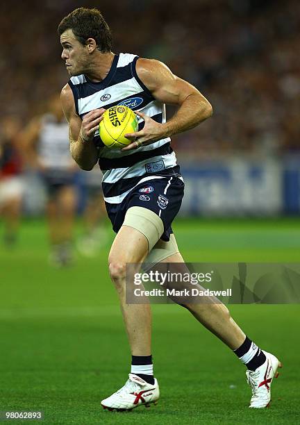 Cameron Mooney of the Cats gathers the ball during the round one AFL match between the Geelong Cats and the Essendon Bombers at Melbourne Cricket...
