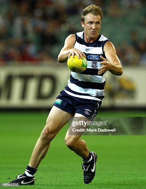 Darren Milburn of the Cats looks for a teammate during the round one AFL match between the Geelong Cats and the Essendon Bombers at Melbourne Cricket...