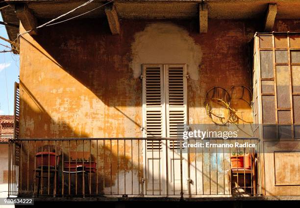 old house balcony flooded with sunlight, avigliana, turin, piedmont, italy - radice stock-fotos und bilder