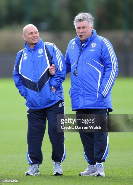 Chelsea manager Carlo Ancelotti helps his injured Assistant Ray Wilkins during a training session at the Cobham training ground on March 26, 2010 in...