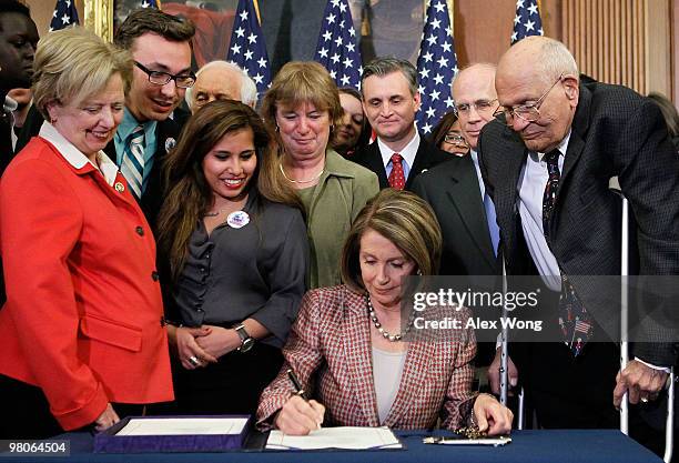 Speaker of the House Rep. Nancy Pelosi signs the revised Health Care and Education Reconciliation Act during an enrollment ceremony as Rep. Mary Jo...