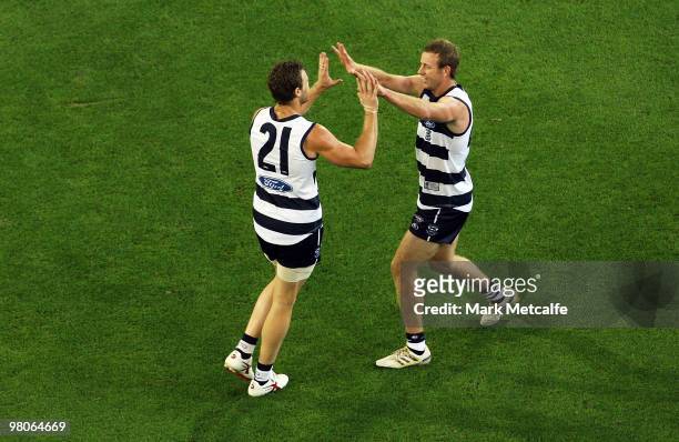 Cameron Mooney and Steve Johnson of the Cats celebrate a goal during the round one AFL match between the Geelong Cats and the Essendon Bombers at...