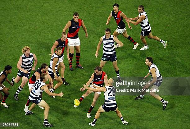 Andrew Welsh of the Bombers kicks out of the pack during the round one AFL match between the Geelong Cats and the Essendon Bombers at Melbourne...