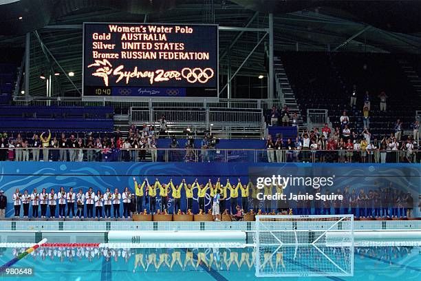 The gold, silver and bronze placed countries, Australia, USA and Russia line-up to receive their medals during the Women's Water Polo held at the...