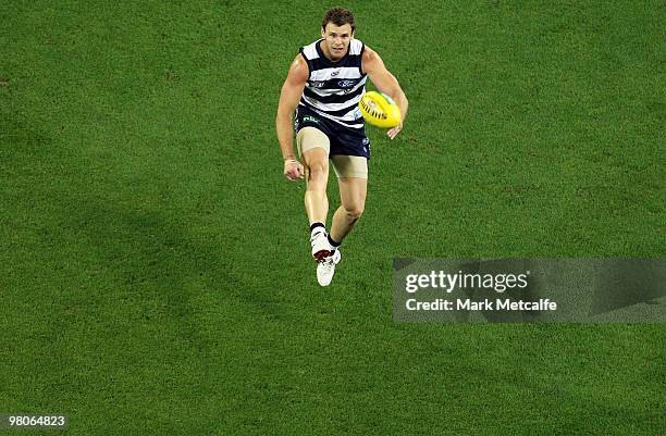 Cameron Mooney of the Cats kicks a goal during the round one AFL match between the Geelong Cats and the Essendon Bombers at Melbourne Cricket Ground...