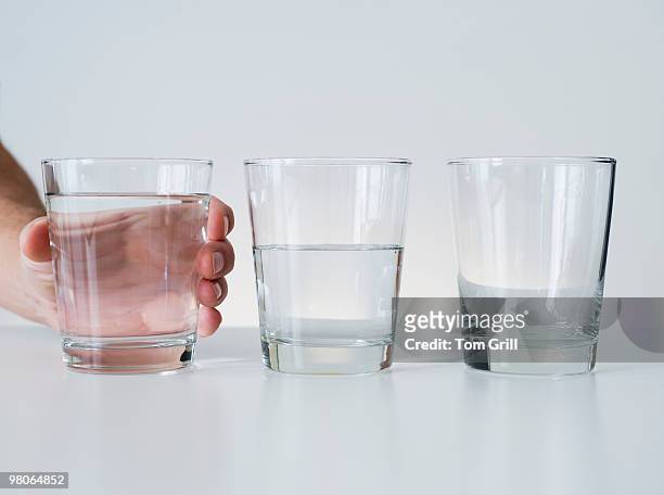 glasses of water in a row - empty glass stock pictures, royalty-free photos & images