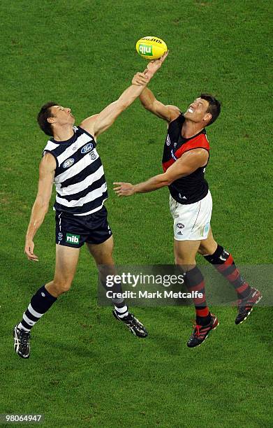 Mark Blake of the Cats and David Hille of the Bombers compete for the ball during the round one AFL match between the Geelong Cats and the Essendon...