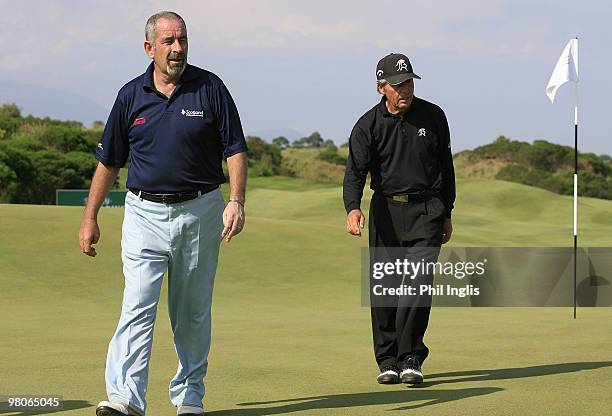 Sam Torrance of Scotland with his playing partner Gary Player of South Africa during the first round of the Berenberg Bank Masters played over The...