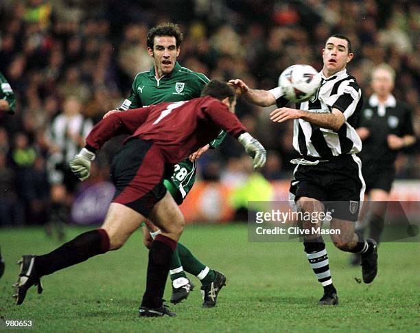 Notts County's Andy Hughes is denied as Wimbledon goalkeeper Kelvin Davis heads the ball away and team mate Peter Hawkins looks on during the AXA...