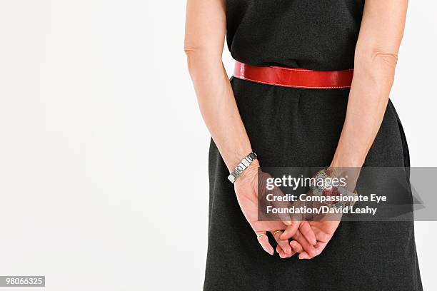 woman's hands behind her back - vista trasera de tres cuartos fotografías e imágenes de stock