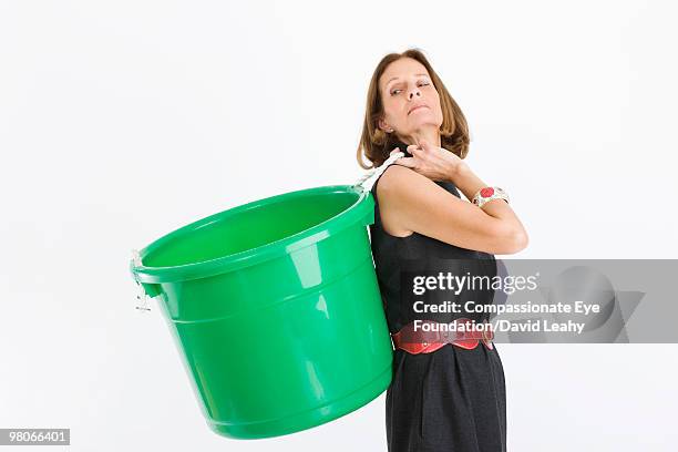 woman holding a green plastic container - david leahy studio stock pictures, royalty-free photos & images