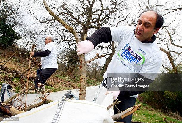 Volunteers help with tidying up during the NatWest CricketForce at Harrow Saint Mary's Cricket Club on March 26, 2010 in London, England. 85,000...