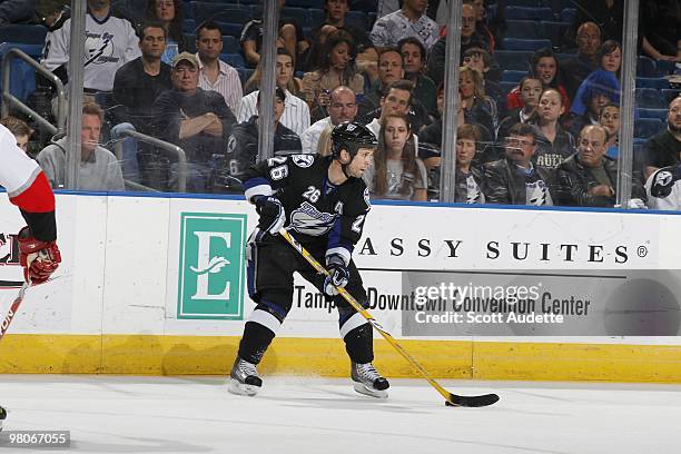Martin St. Louis of the Tampa Bay Lightning passes the puck against the Carolina Hurricanes at the St. Pete Times Forum on March 23, 2010 in Tampa,...