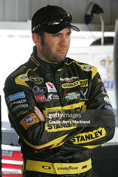 Elliott Sadler, driver of the Stanley Ford stands in the garage area during practice for the NASCAR Sprint Cup Series Goody's Fast Pain Relief 500 at...