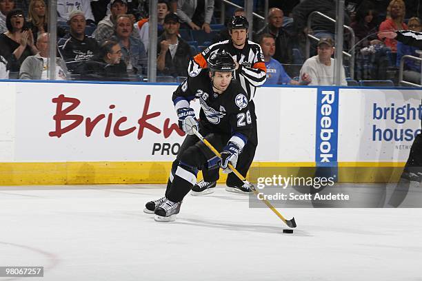 Martin St. Louis of the Tampa Bay Lightning skates with the puck against the Carolina Hurricanes at the St. Pete Times Forum on March 23, 2010 in...