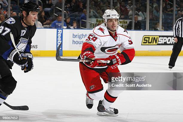 Chad LaRose of the Carolina Hurricanes races to the puck against the Tampa Bay Lightning at the St. Pete Times Forum on March 23, 2010 in Tampa,...