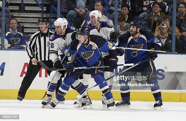 David Backes and Mike Weaver of the St. Louis Blues defend against Jarret Stoll and Ryan Smyth of the Los Angeles Kings on March 25, 2010 at...