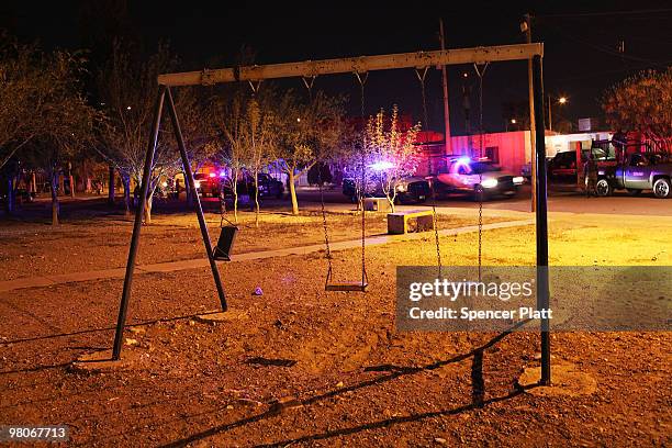 Swing set is empty of children at a crime scene involving the killing of a 13 year old boy in a car, one of numerous murders over a 24 hour period,...