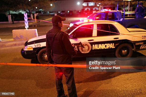 Police gather at an early morning murder, one of numerous murders over a 24 hour period, on March 26, 2010 in Juarez, Mexico. Secretary of State...