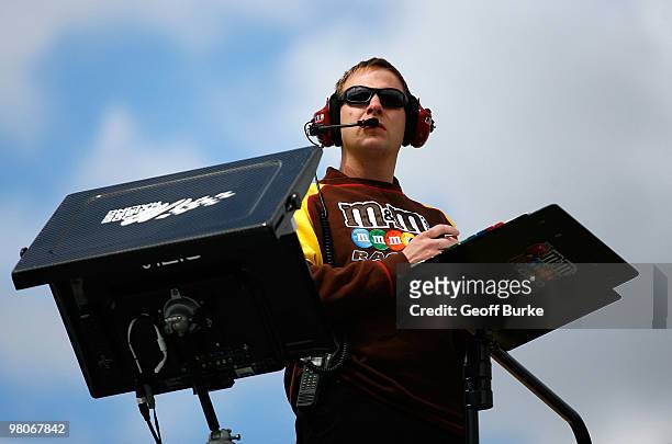 Dave Rogers, crew chief for the Snickers Toyota, watches from atop the team hauler during practice for the NASCAR Sprint Cup Series Goody's Fast Pain...