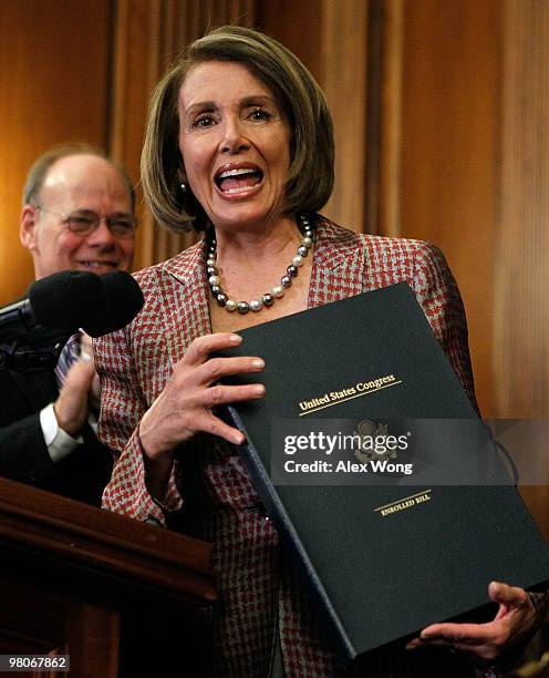 Speaker of the House Rep. Nancy Pelosi rejoices as she holds the box that carries the revised Health Care and Education Reconciliation Act after she...