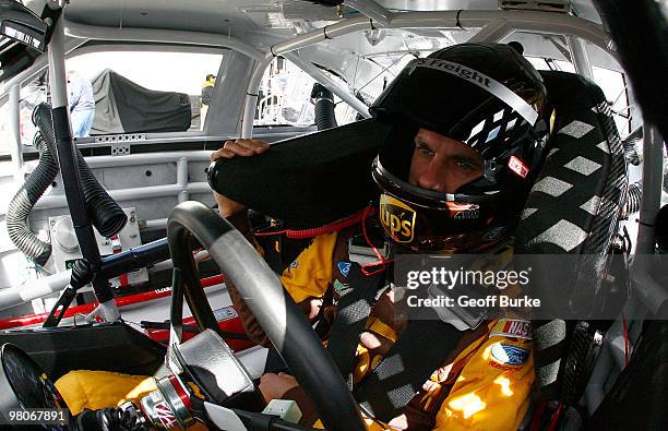 David Ragan, driver of the UPS Ford, sits in his car during practice for the NASCAR Sprint Cup Series Goody's Fast Pain Relief 500 at Martinsville...