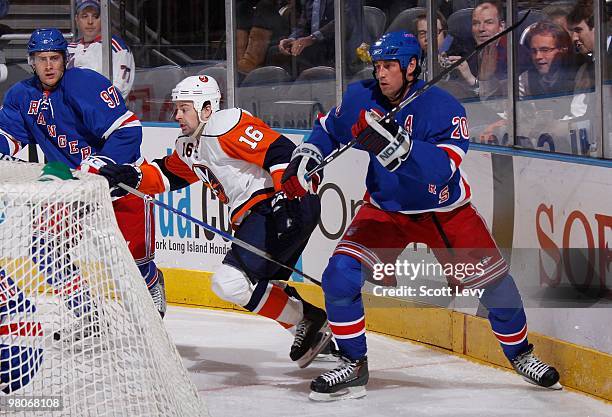 Vinny Prospal and Matt Gilroy of the New York Rangers skate against Jon Sim of the New York Islanders on March 24, 2010 at Madison Square Garden in...