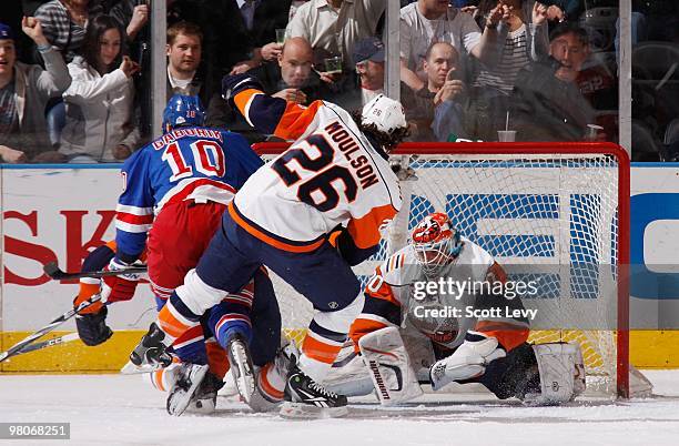 Goaltender Dwayne Roloson of the New York Islanders fails to protect the net against Marian Gaborik of the New York Rangers in the first period on...