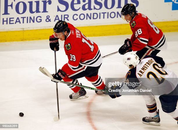 Jonathan Toews of the Chicago Blackhawks moves to the puck in front of teammate Patrick Kane and Colby Armstrong of the Atlanta Thrashers at the...