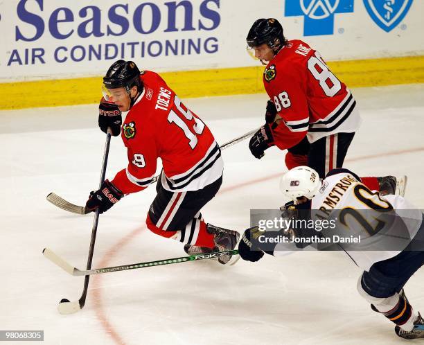 Jonathan Toews of the Chicago Blackhawks moves to the puck in front of teammate Patrick Kane and Colby Armstrong of the Atlanta Thrashers at the...