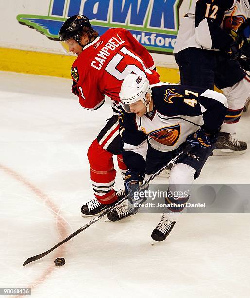 Rich Peverley of the Atlanta Thrashers controls the puck in front of Brian Campbell of the Chicago Blackhawks at the United Center on February 13,...