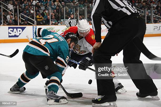 Steven Reinprecht of the Florida Panters takes a face-off against Scott Nichol of the San Jose Sharks during an NHL game on March 13, 2010 at HP...