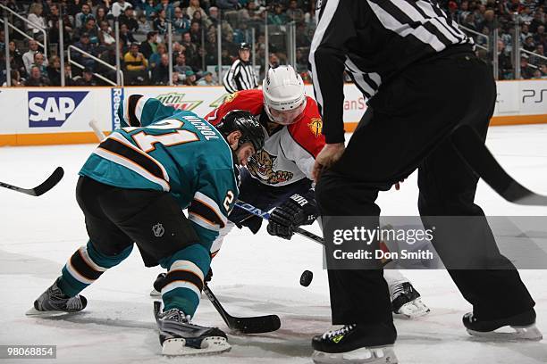 Steven Reinprecht of the Florida Panters takes a face-off against Scott Nichol of the San Jose Sharks during an NHL game on March 13, 2010 at HP...