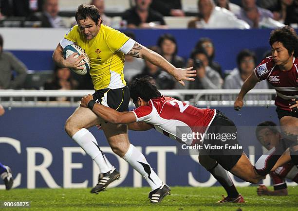 Rhys Shellard of Wales scores a try against Masahiro Tsuiki of Japan on day one of the IRB Hong Kong Sevens on March 26, 2010 in Hong Kong.