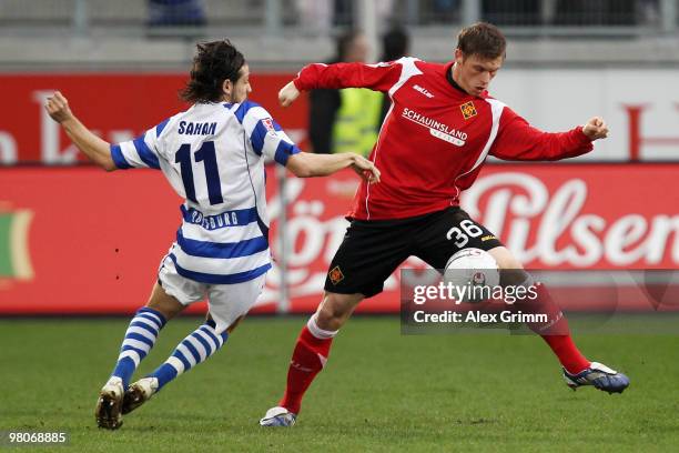 Marvin Pourie of Koblenz is challenged by Olcay Sahan of Duisburg during the Second Bundesliga match between MSV Duisburg and TuS Koblenz at the MSV...