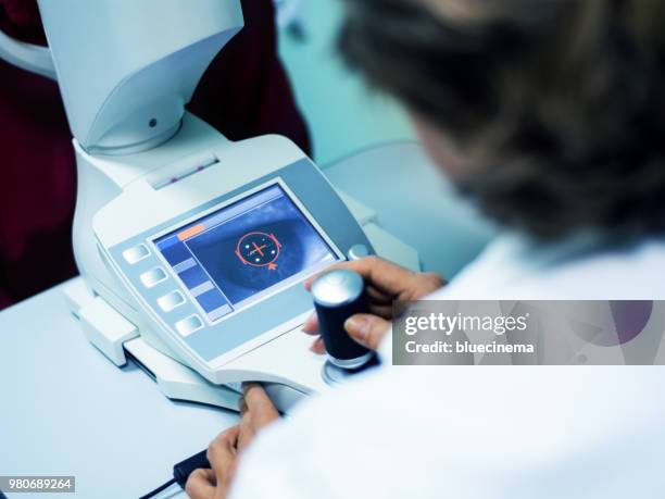 optometry corneal topographer showing an eye and cornea on screen - micro surgery stock pictures, royalty-free photos & images