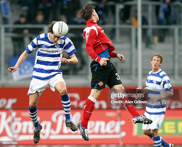 Ivica Grlic of Duisburg jumps for a header with Marvin Pourie of Koblenz during the Second Bundesliga match between MSV Duisburg and TuS Koblenz at...