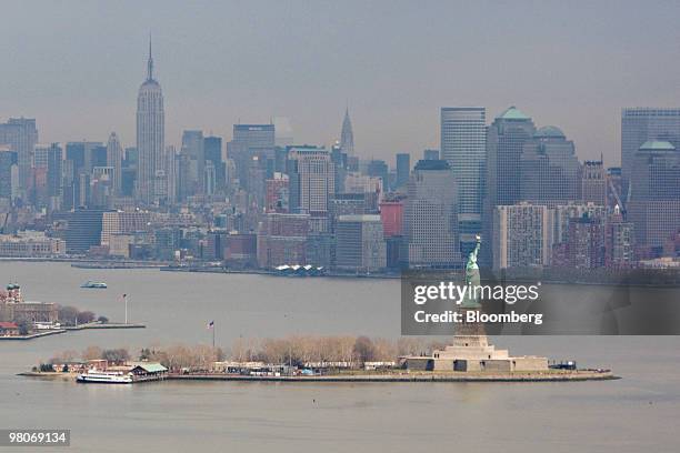 The Manhattan skyline stands beyond the Statue of Liberty as viewed from an A-star 350 B-2 helicopter made by Eurocopter SA, one of six in the fleet...