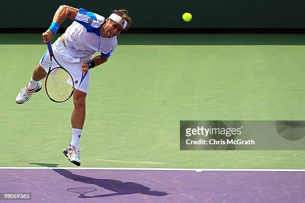 David Ferrer of Spain serves against Michael Llodra of France during day four of the 2010 Sony Ericsson Open at Crandon Park Tennis Center on March...