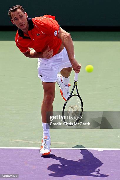 Michael Llodra of France serves against David Ferrer of Spain at the net after their match during day four of the 2010 Sony Ericsson Open at Crandon...