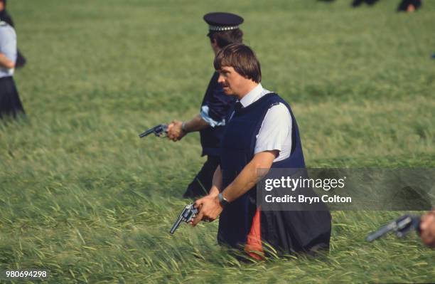 Armed British police officers searching fields during the manhunt for fugitive triple murderer Barry Prudom, Malton, North Yorkshire, June 28, 1982....