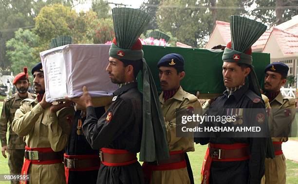 Pakistani soldiers carry a the coffin of a martyred army officer killed during a military operation against militants, during his funeral ceremony in...