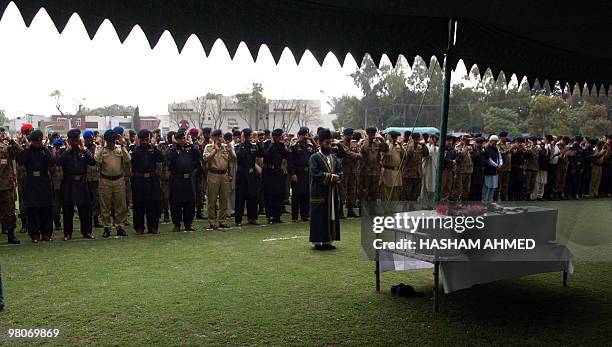 Pakistani military and paramilitary officials offer a funeral prayer for a martyred army officer, killed during a military operation against...