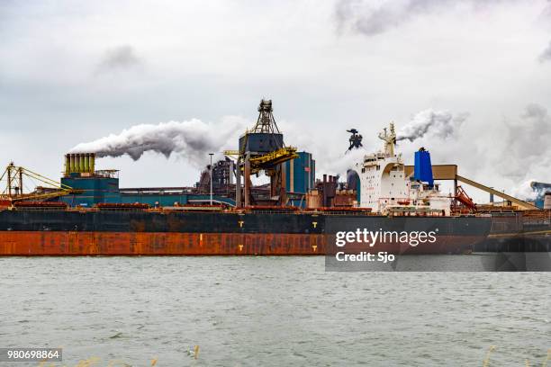 bulk ships unloading cargo at the steel steel mill - kyoto protocol stock pictures, royalty-free photos & images