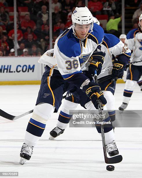 Matt D'Agostini of the St. Louis Blues skates with the puck during an NHL game against the Detroit Red Wings at Joe Louis Arena on March 24, 2010 in...