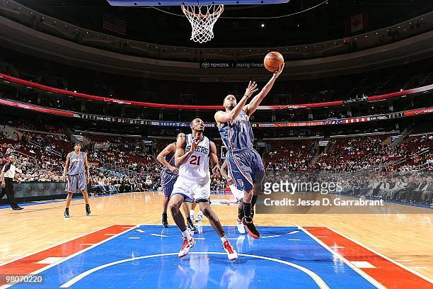 Augustin of the Charlotte Bobcats goes to the basket against Thaddeus Young of the Philadelphia 76ers during the game on March 10, 2010 at Wachovia...