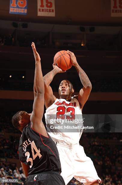 Terrence Jennings of the Louisville Cardinals takes a shot during the Big East second round College Basketball Championship game against the...