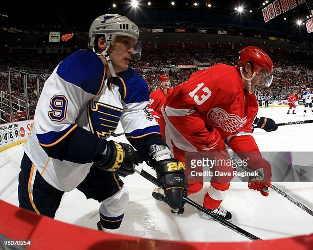 Paul Kariya of the St.Louis Blues skates along the boards as Pavel Datsyuk of the Detroit Red Wings defends during an NHL game at Joe Louis Arena on...