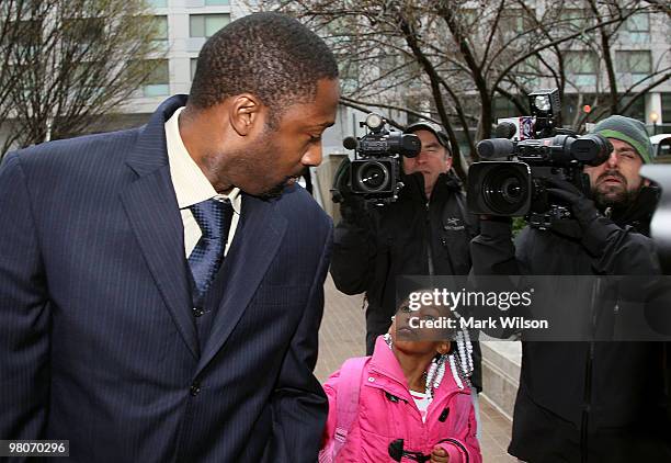 Player Gilbert Arenas of the Washington Wizards is asked for his autograph by 7-year-old Meagan Tutt before he walks into the District of Columbia...