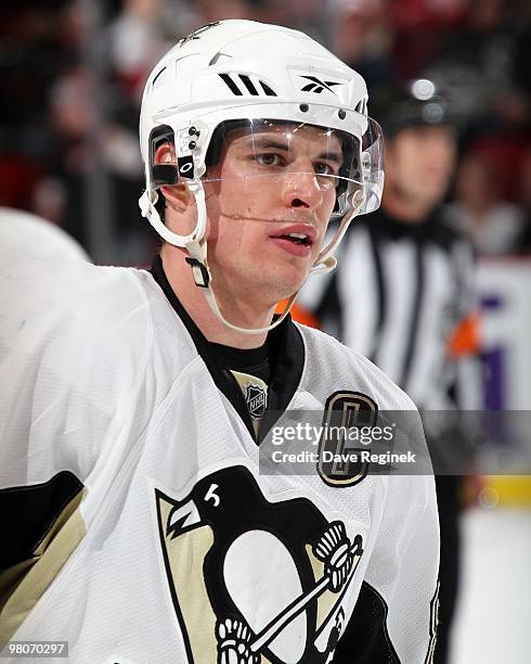 Sidney Crosby of the Pittsburgh Penguins looks down the ice during an NHL game against the Detroit Red Wings at Joe Louis Arena on March 22, 2010 in...